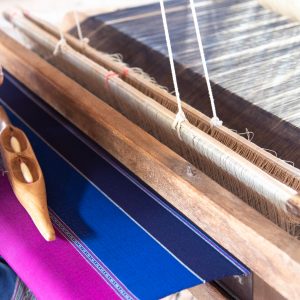 People are weaving with traditional Thai Lanna weaving machines